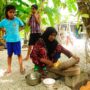 WHO Maldives / Ibrahim Asad A mother is using traditional Maldivian cooking utensils to prepare a meal for her children. Credits